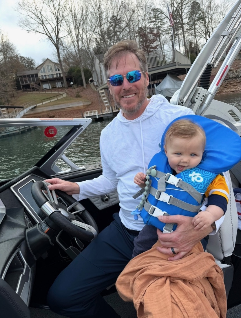 Trip at the helm with his youngest grandchild on Lake Hartwell