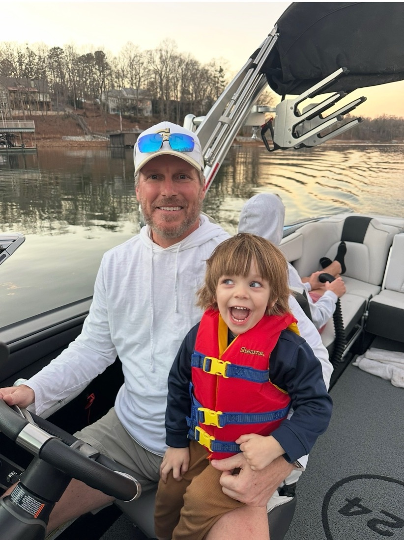 Trip at the helm with a grandchild at sunset on Lake Hartwell